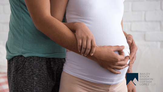 image of a pregnant woman with partner behind her