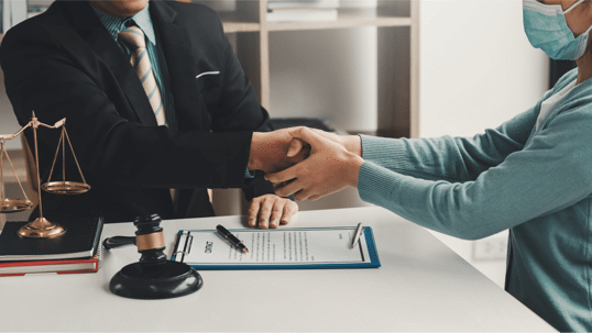 client shaking hands with a lawyer