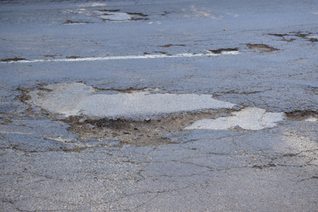 deteriorated infrastructure in a parking lot