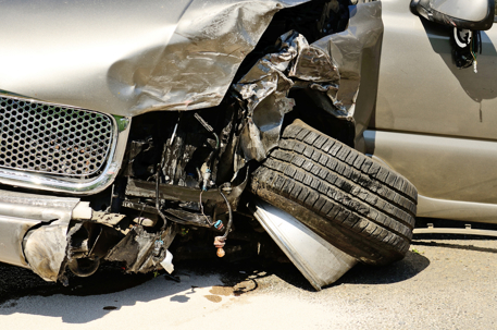 The front end of a large SUV folloing a two car accident resulting in injuries