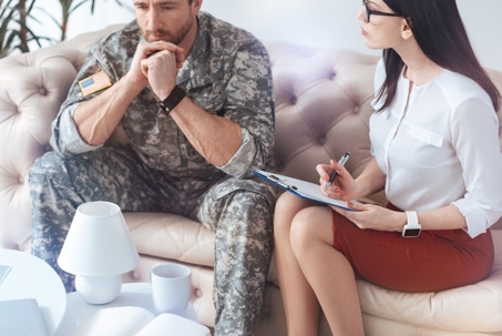military man sits with a professional
